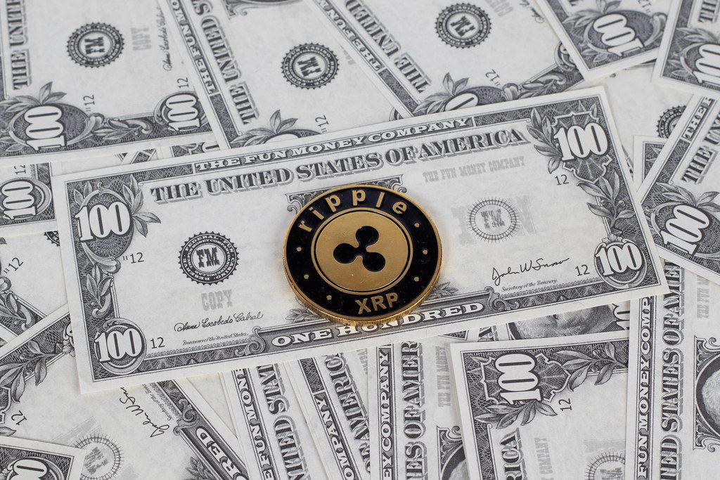 "Ripple coin and dollar bills" by marcoverch (licensed under CC BY 2.0)